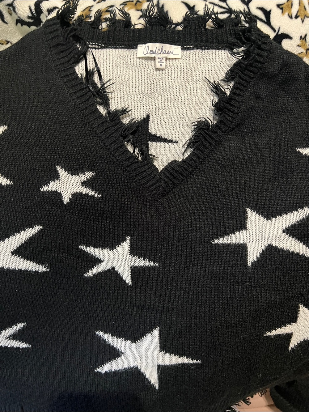 Cloud Chaser Black V-Neck Sweater with White Star Pattern